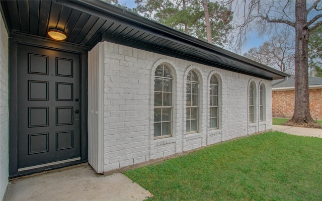 doorway to property with a yard