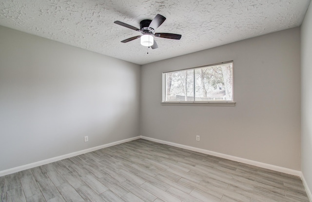 empty room featuring ceiling fan, a textured ceiling, and light wood-type flooring