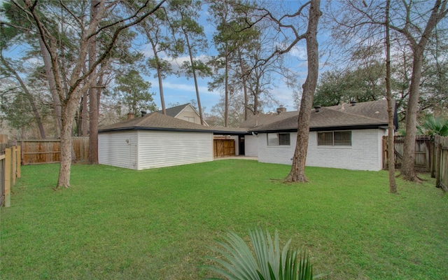 rear view of property with a lawn