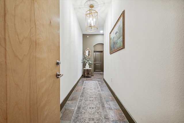 hall featuring a notable chandelier