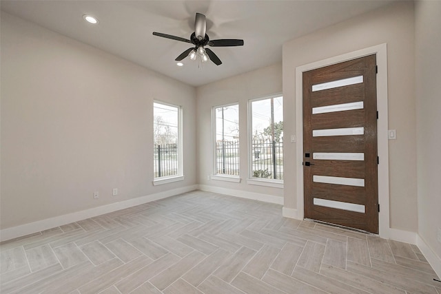 entryway featuring ceiling fan and light parquet flooring