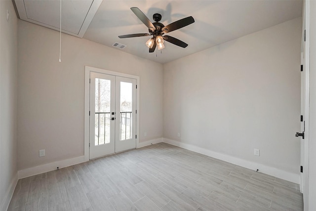 spare room with light hardwood / wood-style floors and french doors