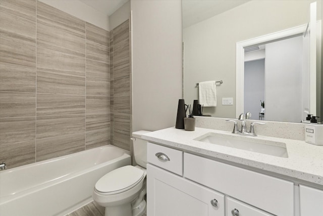 full bathroom with toilet, vanity, and tiled shower / bath