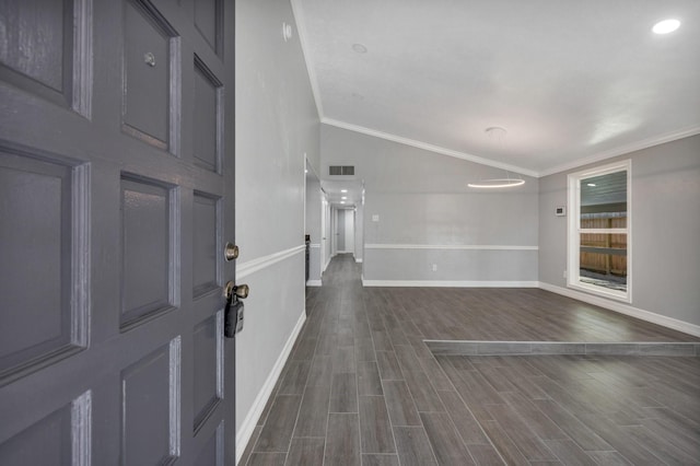 foyer entrance with crown molding, lofted ceiling, and dark hardwood / wood-style floors