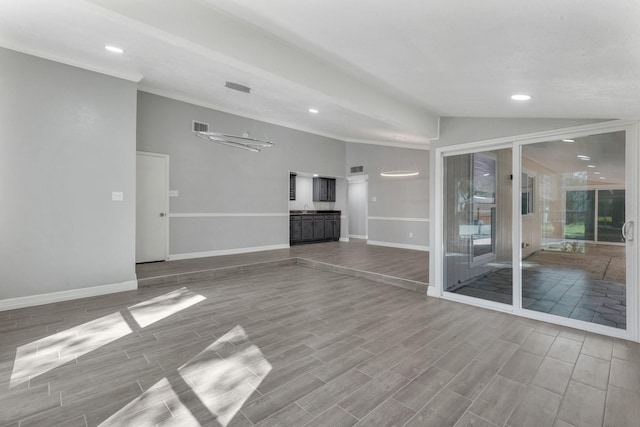 unfurnished living room featuring vaulted ceiling