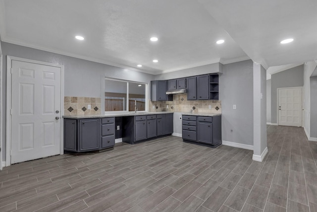 kitchen with sink, light hardwood / wood-style flooring, gray cabinets, ornamental molding, and decorative backsplash