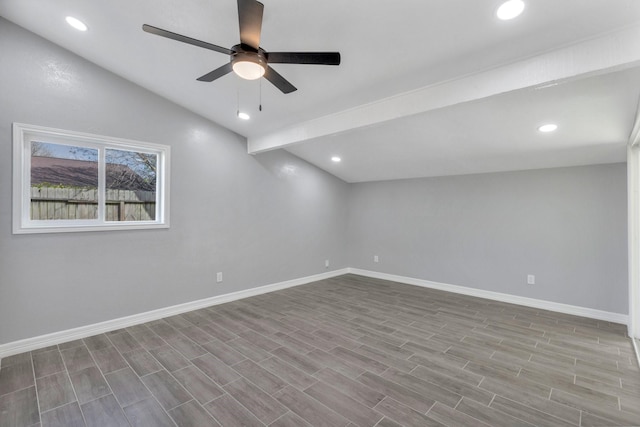 empty room with ceiling fan, lofted ceiling, and light hardwood / wood-style floors