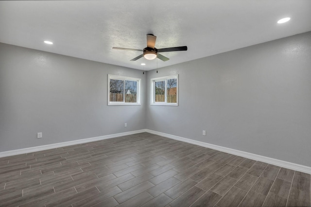 empty room with dark hardwood / wood-style flooring and ceiling fan