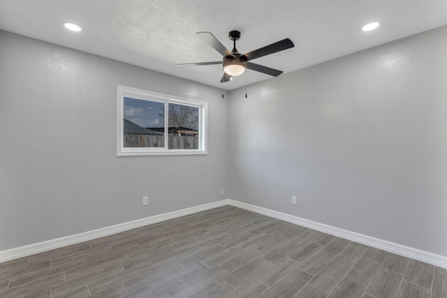 unfurnished room with a textured ceiling, light hardwood / wood-style flooring, and ceiling fan