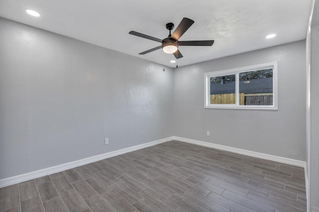 empty room with ceiling fan and light hardwood / wood-style flooring