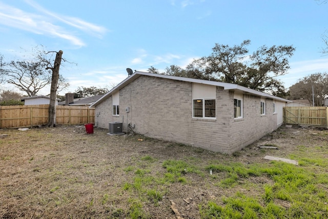 back of house featuring central AC unit