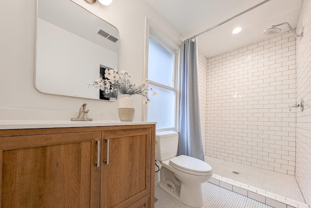 bathroom featuring tile patterned flooring, vanity, toilet, and walk in shower