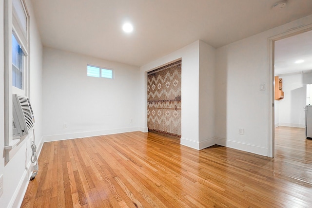 unfurnished room with hardwood / wood-style flooring