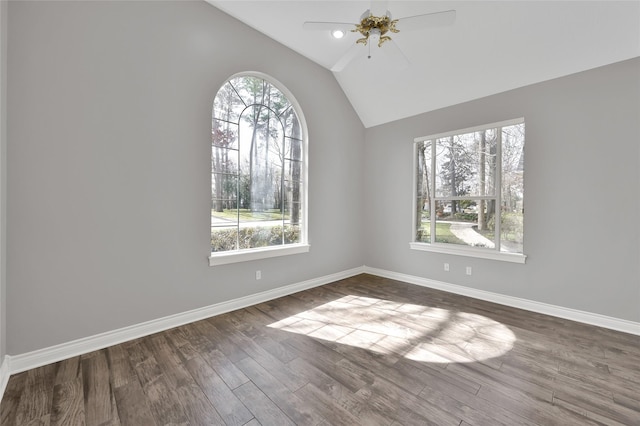 spare room featuring ceiling fan, plenty of natural light, vaulted ceiling, and hardwood / wood-style floors