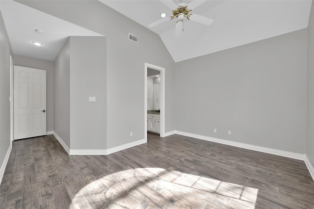 unfurnished bedroom with vaulted ceiling, dark hardwood / wood-style floors, ceiling fan, and ensuite bathroom