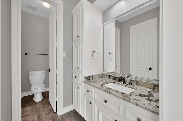 bathroom with vanity, hardwood / wood-style floors, and toilet