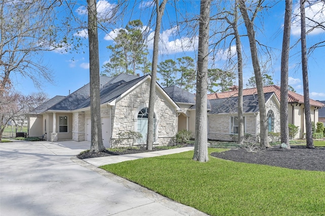 view of front of home with a garage and a front lawn