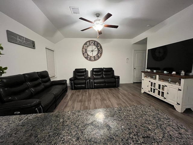 living room featuring dark hardwood / wood-style flooring, lofted ceiling, and ceiling fan