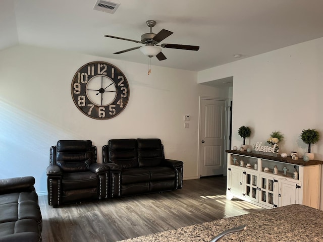 living room featuring vaulted ceiling, dark hardwood / wood-style floors, and ceiling fan