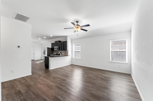 unfurnished living room with lofted ceiling, ceiling fan, and dark hardwood / wood-style floors