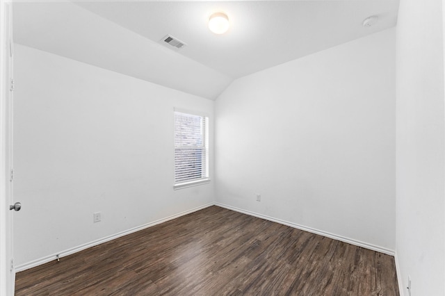 unfurnished room featuring dark wood-type flooring and lofted ceiling