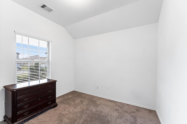 unfurnished bedroom featuring vaulted ceiling and carpet flooring