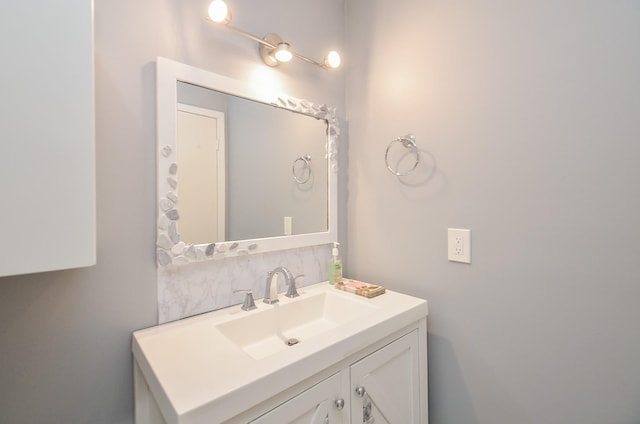 bathroom with vanity and decorative backsplash