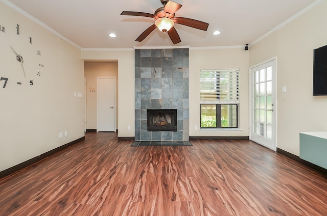 unfurnished living room featuring crown molding, dark wood-type flooring, and a tile fireplace