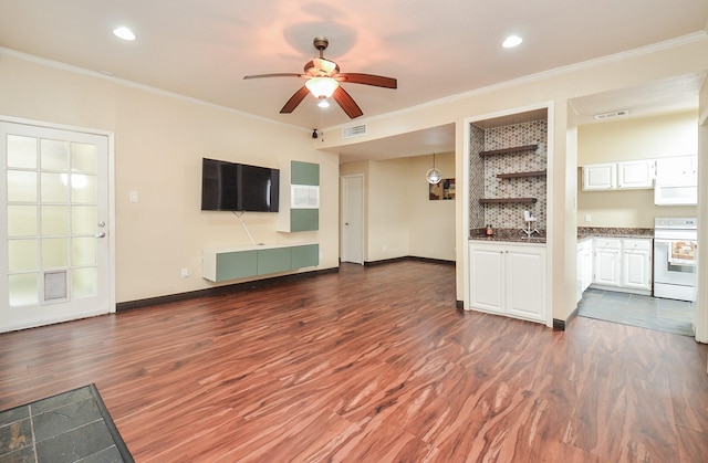 unfurnished living room featuring crown molding, ceiling fan, and dark hardwood / wood-style floors