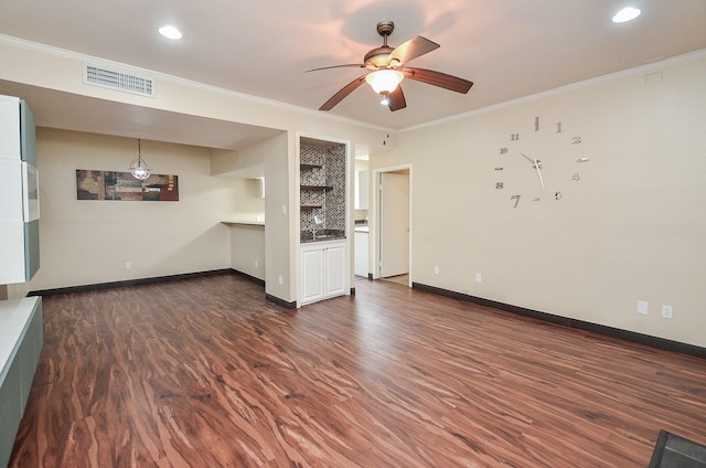 unfurnished living room with crown molding, dark wood-type flooring, and ceiling fan