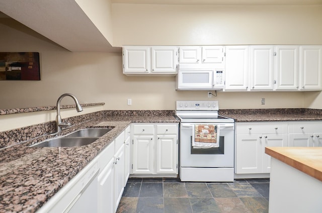 kitchen featuring sink, white cabinets, and white appliances