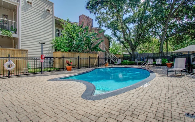 view of swimming pool with a patio