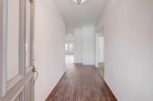 hall with baseboards and dark wood-style flooring