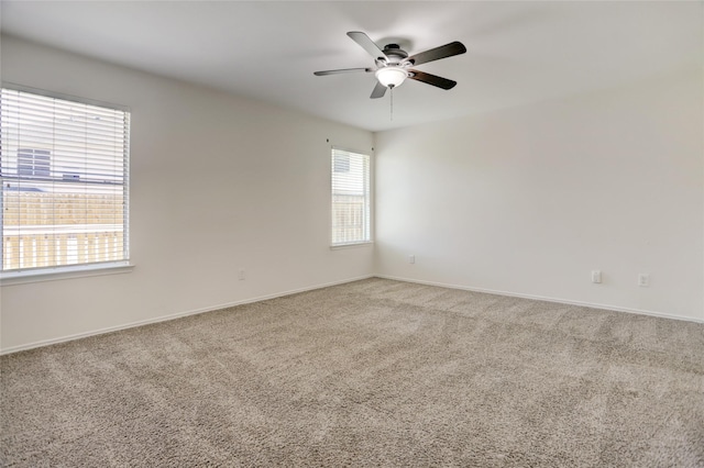 spare room with baseboards, ceiling fan, and carpet floors