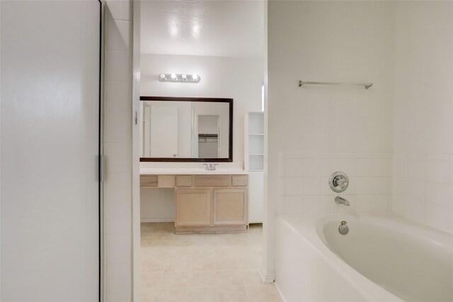 full bathroom with a garden tub and vanity