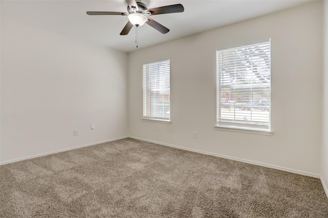 unfurnished room with baseboards, ceiling fan, and carpet flooring