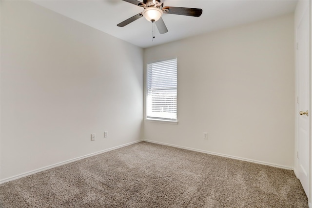 unfurnished room with baseboards, a ceiling fan, and carpet flooring