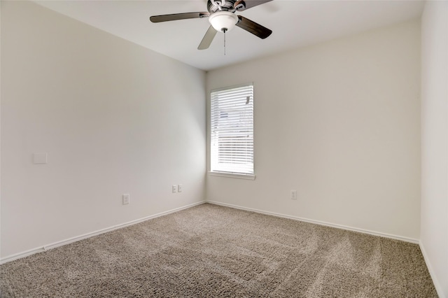 carpeted spare room with baseboards and ceiling fan