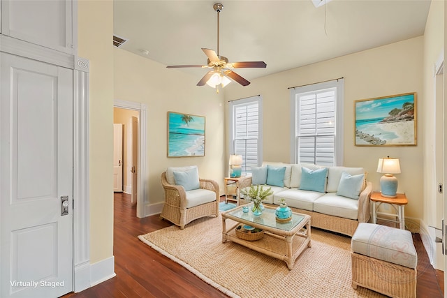 living room featuring a ceiling fan, dark wood-style flooring, visible vents, and baseboards