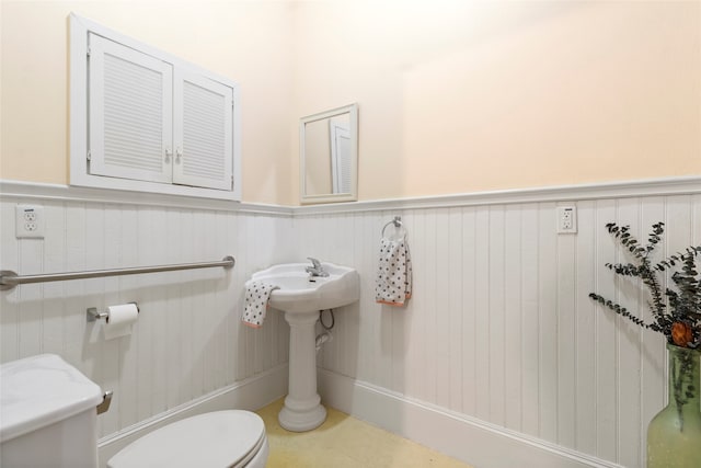 1621 Ursuline St, Galveston, TX 77550 - bathroom featuring toilet and a wainscoted wall