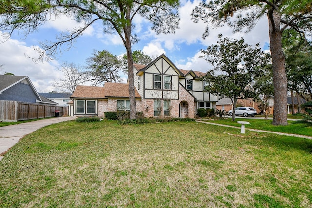 tudor-style house with a front lawn