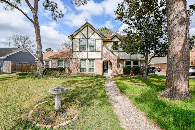 tudor-style house with a front yard