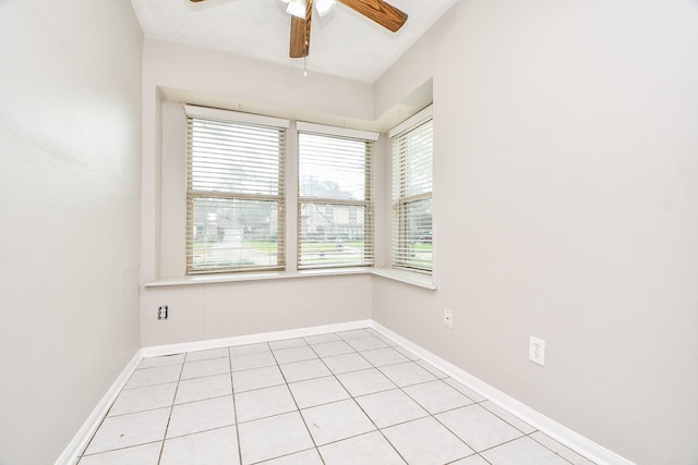 empty room with ceiling fan and light tile patterned flooring