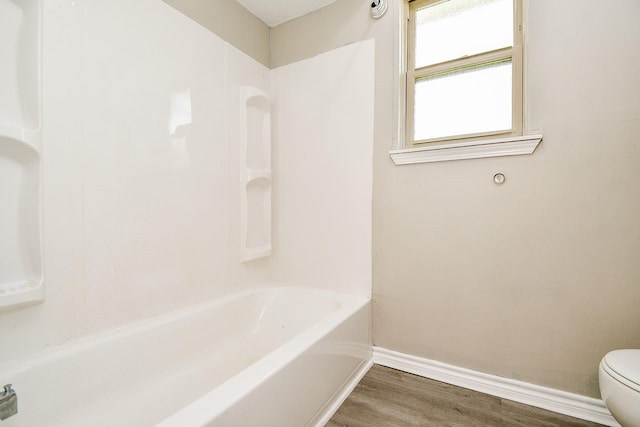 bathroom featuring wood-type flooring and toilet