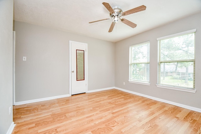 empty room with light hardwood / wood-style flooring and ceiling fan