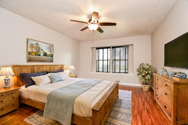 bedroom featuring ceiling fan and dark hardwood / wood-style flooring