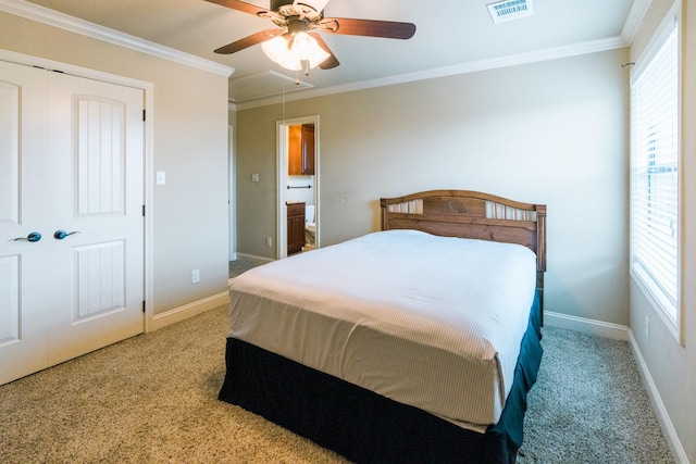 bedroom featuring ornamental molding, light carpet, ceiling fan, and a closet