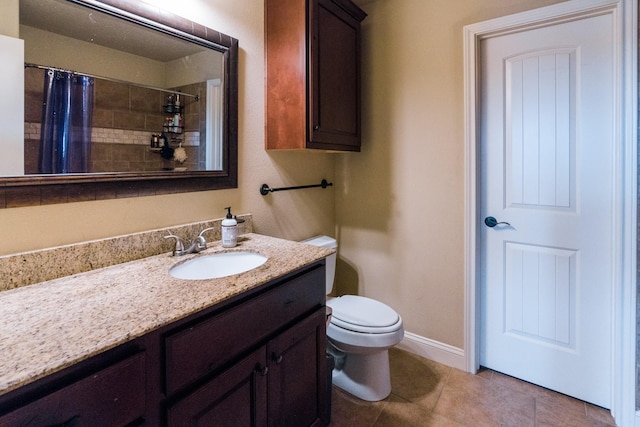 bathroom with a shower with curtain, vanity, toilet, and tile patterned flooring