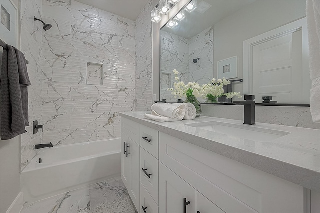 bathroom featuring tiled shower / bath and vanity