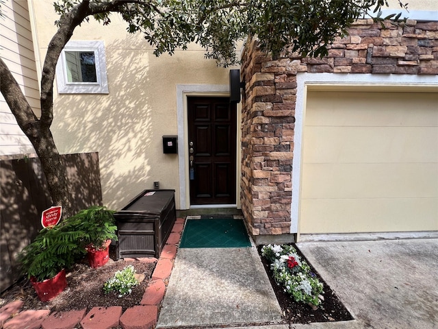 doorway to property with a garage